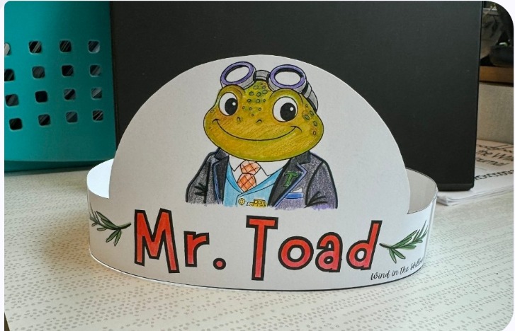 Wearable paper crown with a colored Mr. Toad in goggles and the words Mr. Toad